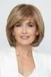 Woman in a shoulder length ginger blonde bob wig with side bangs