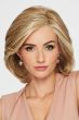 Woman in large short blonde bob lace front wig with a blow-out style and curled under ends
