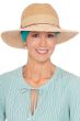 Woman in brimmed straw fedora hat with wide headband underneath for chemo patients