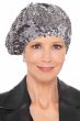 Woman in beret hat embellished with silver sequins throughout