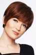 Woman in a long layered medium auburn pixie wig with fringe bangs