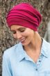 Middle aged woman outdoors wearing red slouchy snood chemo hat
