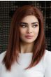 Woman in a past the shoulders straight dark brown wig with long layers