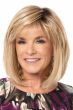 Woman in a shoulder length medium blonde bob wig with wispy bangs