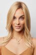 Woman in a past the shoulders blonde human hair wig with long layers