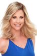 Woman in a 12" light blonde semi-curly lace front hair topper with side bangs