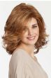 Woman in a past the shoulders layered light red wig