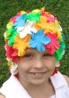 Little girl in old fashioned rubber multi colored flowered swim cap