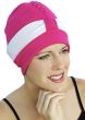Woman in hot pink turban style swim cap with white band