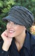 Woman outdoors wearing a grey cancer hat with brim and pleats