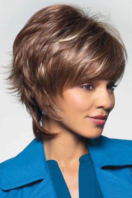 Woman in brown short to shoulder length bi level style wig with highlights, layers and bangs