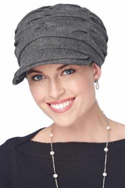 Woman wearing grey fall and winter newsboy hat with brim and multiple pleats