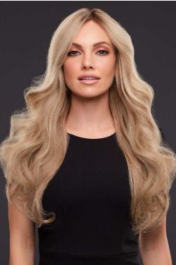 Woman in an extra long light golden brown and blonde curly remy human hair lace front wig with dark roots