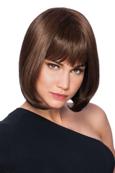 Woman in a straight chin length dark brown wig with blunt bangs