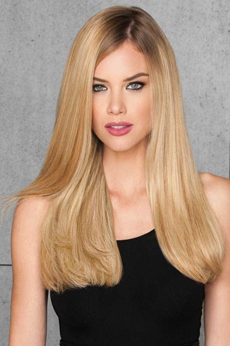 woman in 20" reddish blonde hair extensions attached to her hair
