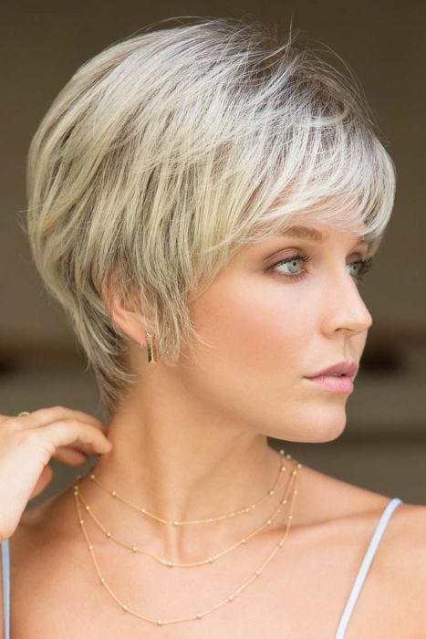 Woman in a platinum blonde semi-asymmetric short bob wig with a side part and side bangs