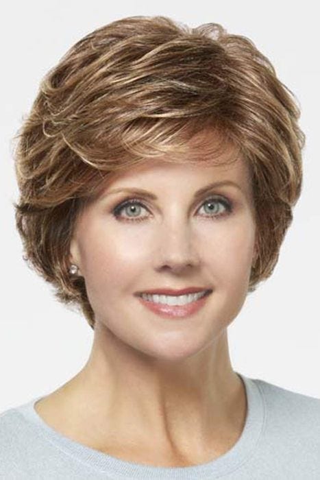 Woman in a short evenly layered red blonde bob wig with side bangs