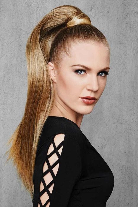 Woman in a reddish blonde 25" ponytail attached to her hair