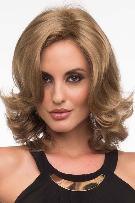Woman in a layered shoulder length curly ash blonde wig