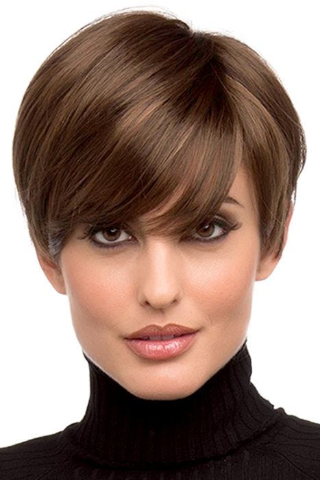 Woman in a long medium brown pixie wig with side swept bangs and shorter hair in back