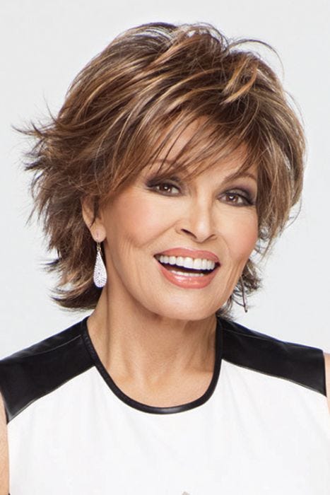 Raquel Welch in a cropped, layered medium brown with ginger highlights bob wig with textured side swept bangs