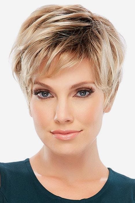 Woman in short light blonde pixie cut wig