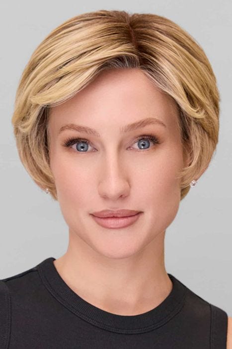 Woman in a blonde classic pixie style wig with feathered bangs and darker layers