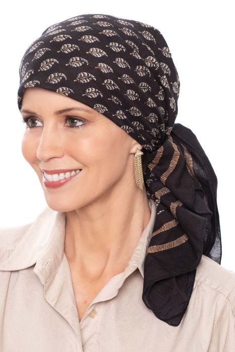 Woman in black cotton head scarf with leaf print
