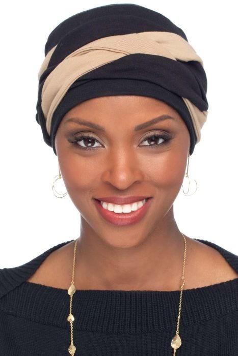 Woman in black vintage style pleated turban for women with cancer