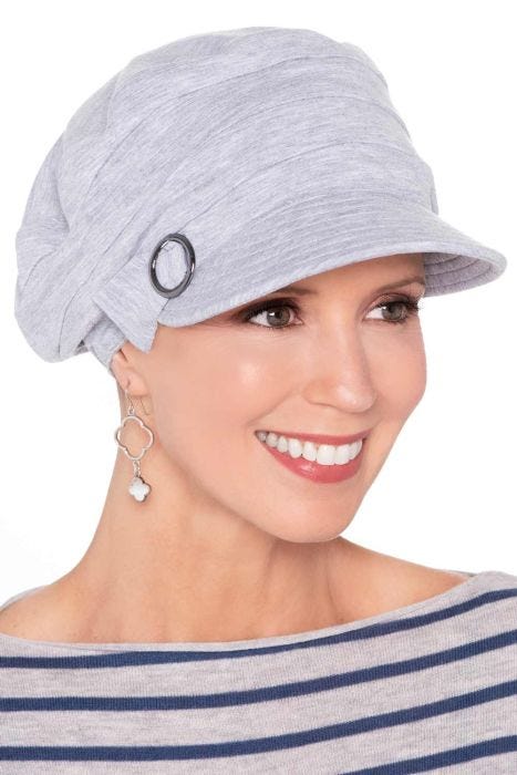 Woman in grey women's newsboy style chemo hat with brim