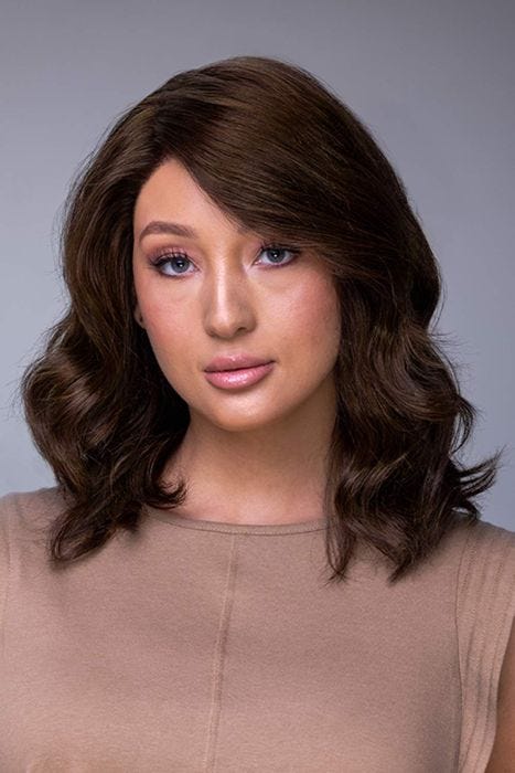 Woman in a petite shoulder length dark brown curly human hair wig