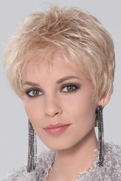 Woman in a tousled light blonde lace front pixie wig