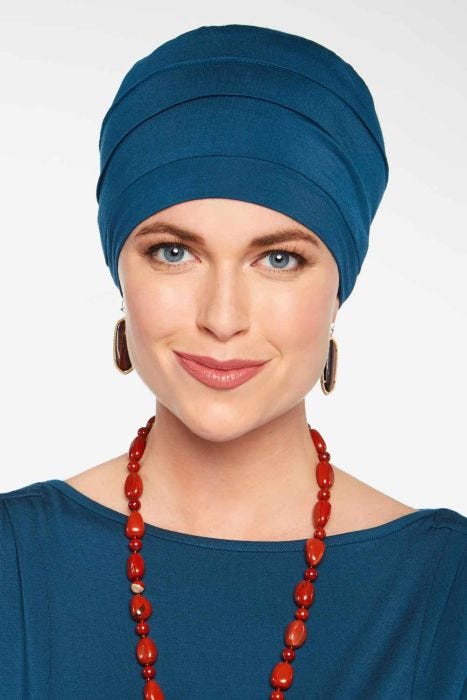 Woman in blue bamboo chemo cap or hat designed for cancer patients