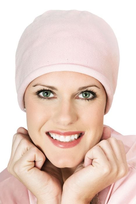 Women in pink cotton knitted beanie sleeping cap for cancer patients