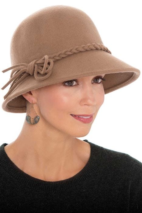 Woman in brown suede wool brimmed outdoor winter hat with braided detail for women with cancer