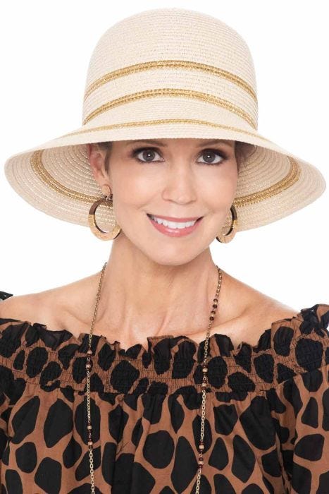 Woman in brimmed summer vacation hat with metallic stripes