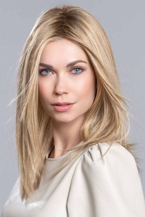 Woman in a 16" straight warm blonde wiglet hair topper for thinning hair