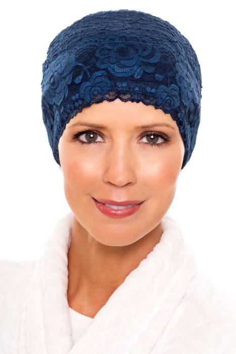 Woman in soft textured silky blue sleeping cap with lace trim in beanie style