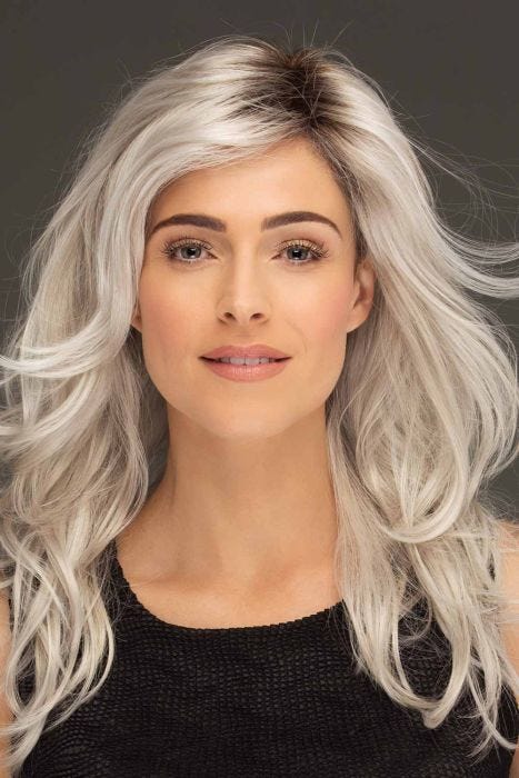Woman in an extra long tousled platinum blonde lace front layered wig