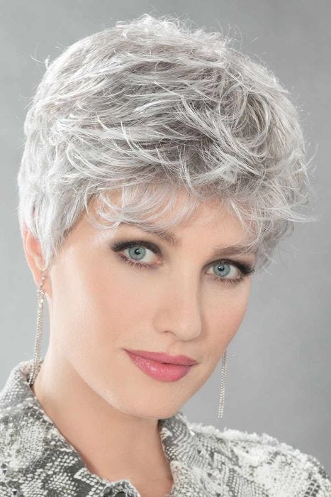 Woman in a light grey pixie wig with longer hair on top