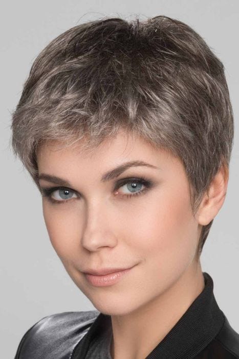 Woman in a light brown lace front pixie wig