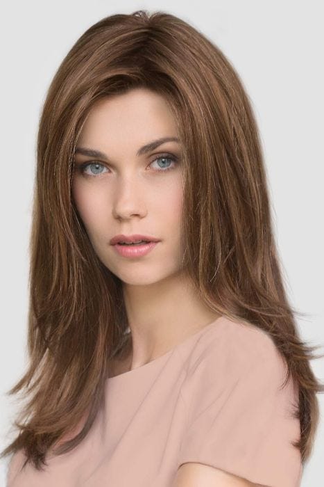 Woman in a past the shoulders straight medium brown lace front wig with long layers