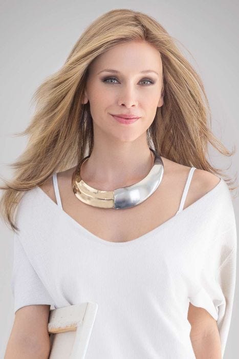 Woman in an extra long medium blonde layered lace front wig
