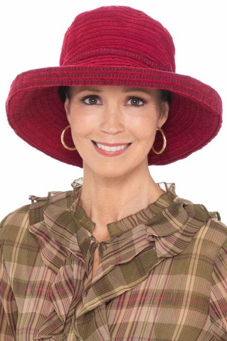 Woman in wide brimmed burgundy fall and winter bucket made with chenille ribbon braids