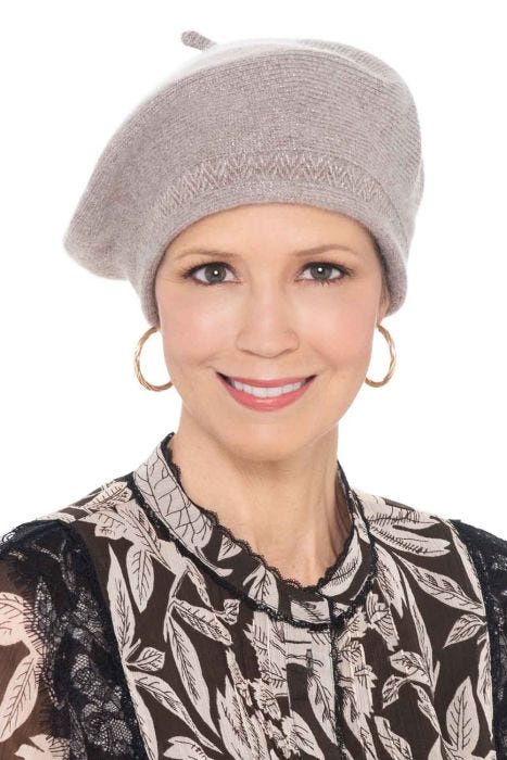 Woman in light taupe winter beret with shimmer and zig zag accents