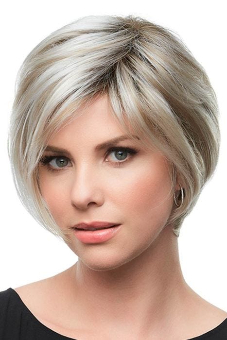Woman in a petite layered chin length blonde rounded bob wig with bangs