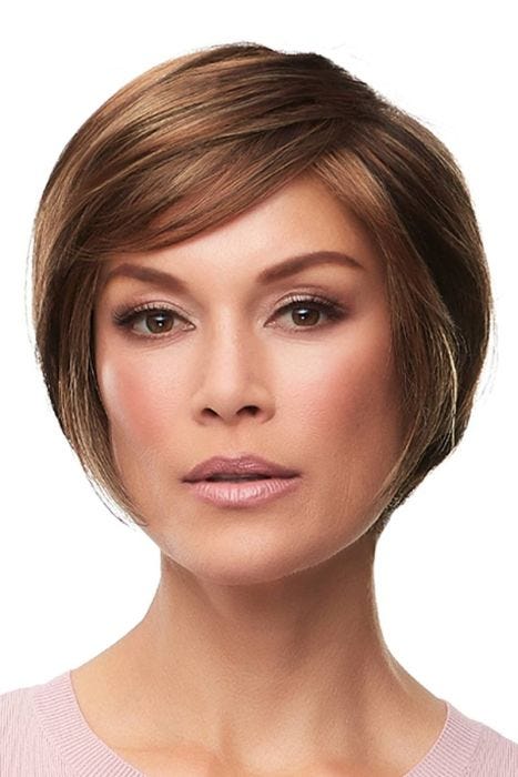 Woman in a layered chin length medium auburn rounded bob wig with bangs