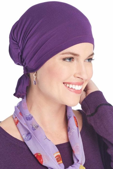 Woman in purple chemo beanie head covering for women