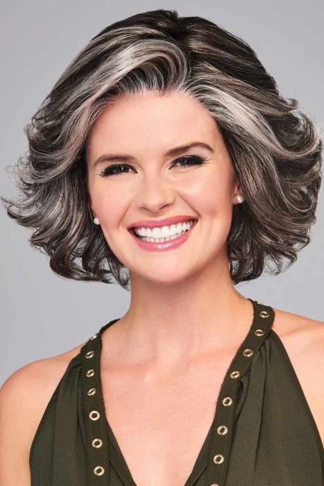Woman in a blown out past the chin grey and black curly wig