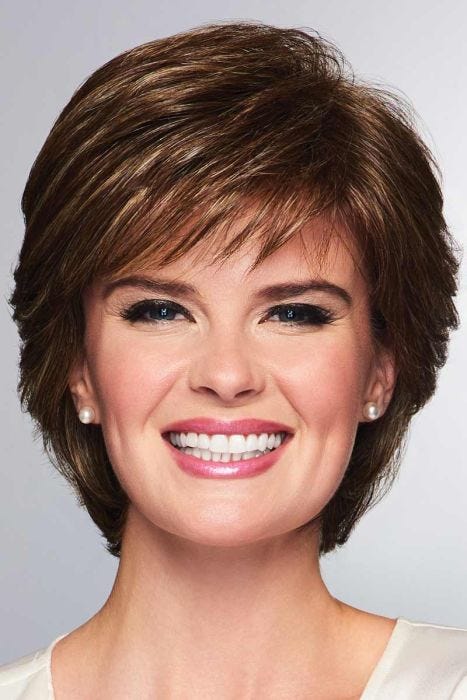 Woman in a layered medium brown short wig with fringe side bangs